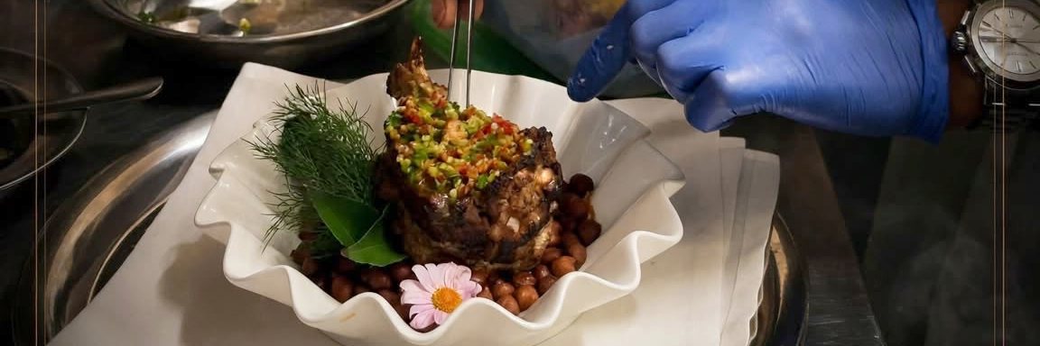 Chef finishing a lamb chop with chilli and herb salsa at 7eventy1, Appleby-in-Westmorland